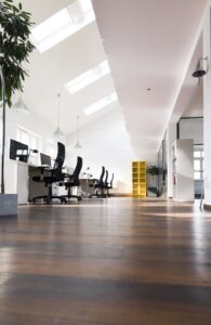 Desks with PCs in bright and modern open space office
